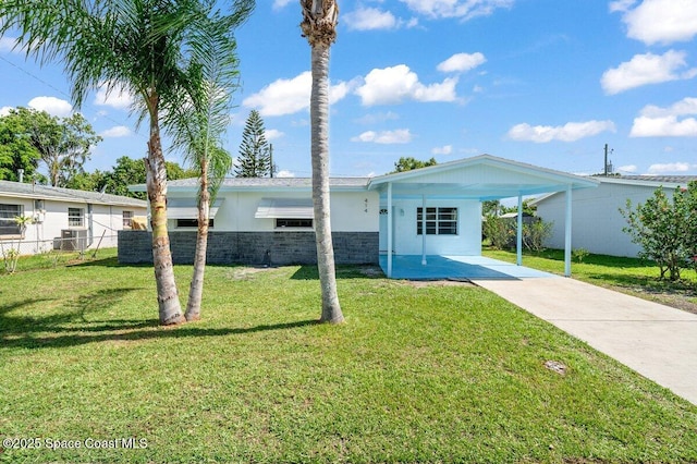 414 Marquis St, Melbourne, FL 32901 - view of front facade featuring driveway, an attached carport, and stone siding