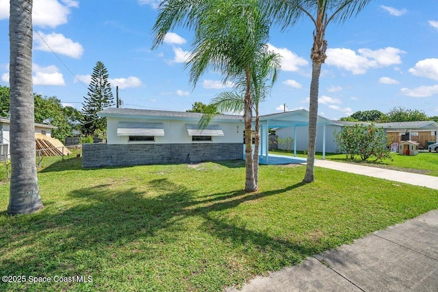 414 Marquis St, Melbourne, FL 32901 - ranch-style house with concrete driveway, stucco siding, a front yard, an attached carport, and stone siding