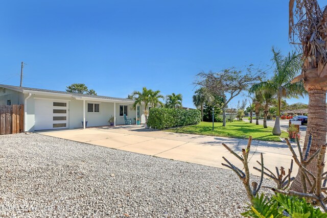 326 Coral Dr, Cape Canaveral, FL 32920 - view of yard with an attached garage and driveway