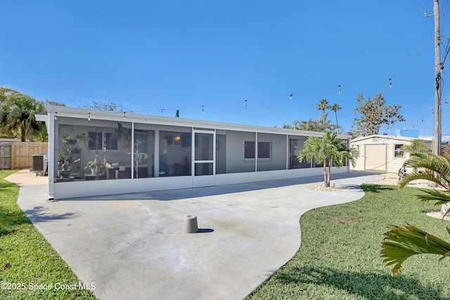 326 Coral Dr, Cape Canaveral, FL 32920 - back of house featuring a sunroom and a patio