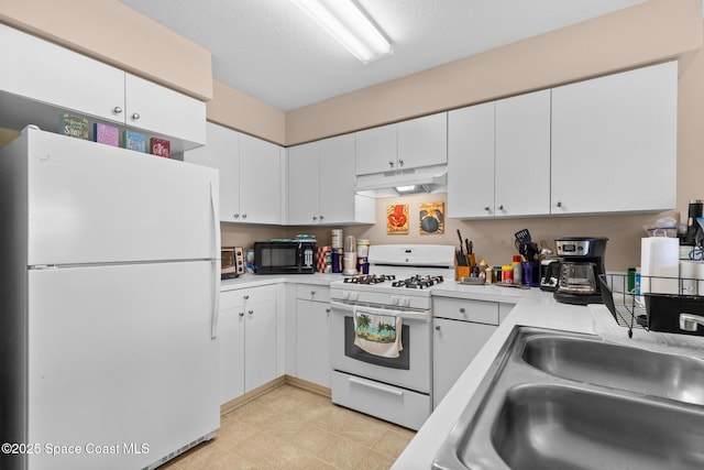 243 Forecast Ln Unit 4-21, Rockledge, FL 32955 - kitchen with white appliances, under cabinet range hood, light countertops, white cabinets, and a sink