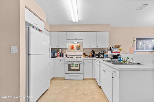243 Forecast Ln Unit 4-21, Rockledge, FL 32955 - kitchen with white appliances, under cabinet range hood, a sink, and light countertops