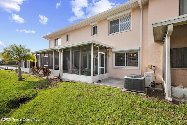 243 Forecast Ln Unit 4-21, Rockledge, FL 32955 - back of property featuring central AC unit, a sunroom, stucco siding, and a lawn