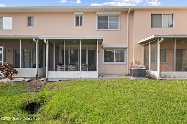 243 Forecast Ln Unit 4-21, Rockledge, FL 32955 - back of property featuring a sunroom, stucco siding, a yard, and central AC