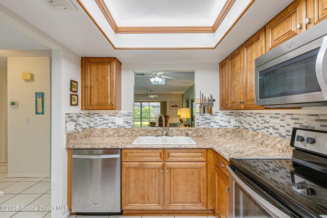 290 Paradise Blvd Unit 61, Indialantic, FL 32903 - kitchen featuring stainless steel appliances, a sink, a ceiling fan, backsplash, and light tile patterned floors