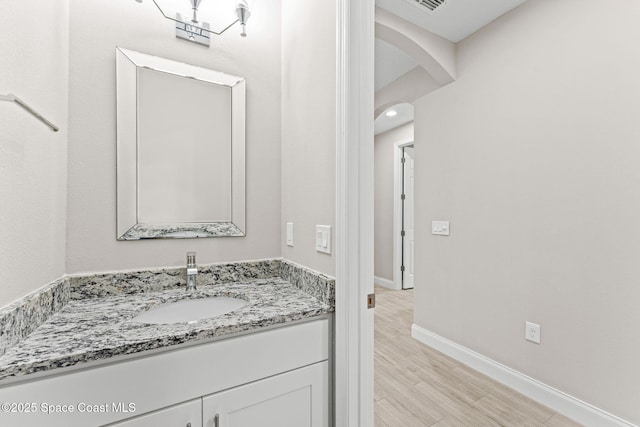 1427 Damon Rd SE, Palm Bay, FL 32909 - bathroom featuring vanity, baseboards, and wood finished floors