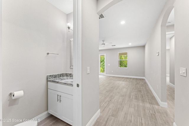 1427 Damon Rd SE, Palm Bay, FL 32909 - bathroom with vanity, a ceiling fan, baseboards, wood finished floors, and recessed lighting
