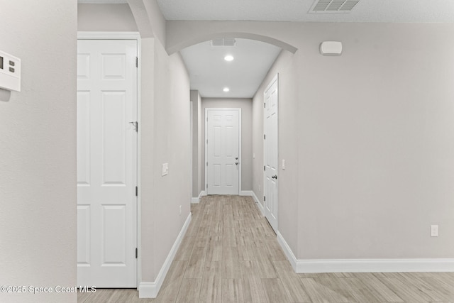 1427 Damon Rd SE, Palm Bay, FL 32909 - hallway with arched walkways, light wood-style floors, baseboards, and recessed lighting
