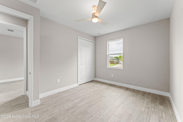 1427 Damon Rd SE, Palm Bay, FL 32909 - unfurnished bedroom with light wood-style flooring, a closet, baseboards, and ceiling fan