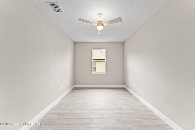 1427 Damon Rd SE, Palm Bay, FL 32909 - spare room with ceiling fan, a textured ceiling, light wood-type flooring, and baseboards