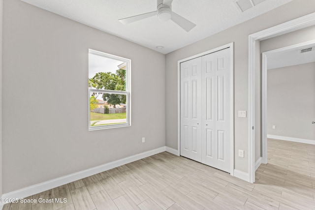 1427 Damon Rd SE, Palm Bay, FL 32909 - unfurnished bedroom with a closet, baseboards, light wood-style floors, and ceiling fan