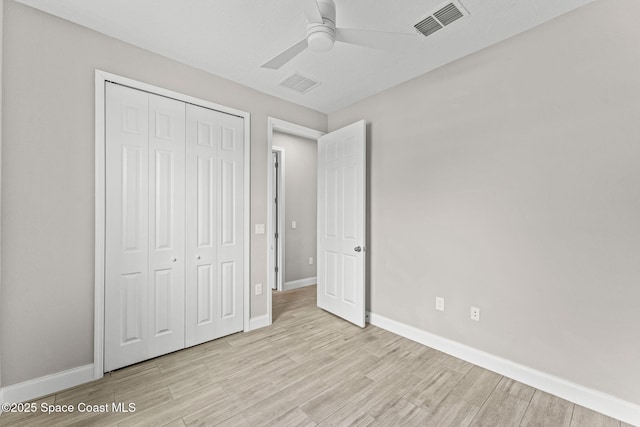 1427 Damon Rd SE, Palm Bay, FL 32909 - unfurnished bedroom featuring light wood-style flooring, a closet, baseboards, and ceiling fan