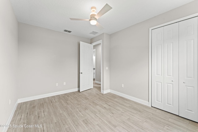 1427 Damon Rd SE, Palm Bay, FL 32909 - unfurnished bedroom featuring light wood-style floors, a closet, baseboards, and ceiling fan