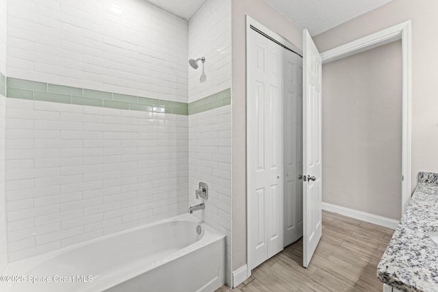 1427 Damon Rd SE, Palm Bay, FL 32909 - bathroom featuring  shower combination, baseboards, wood finished floors, vanity, and a closet
