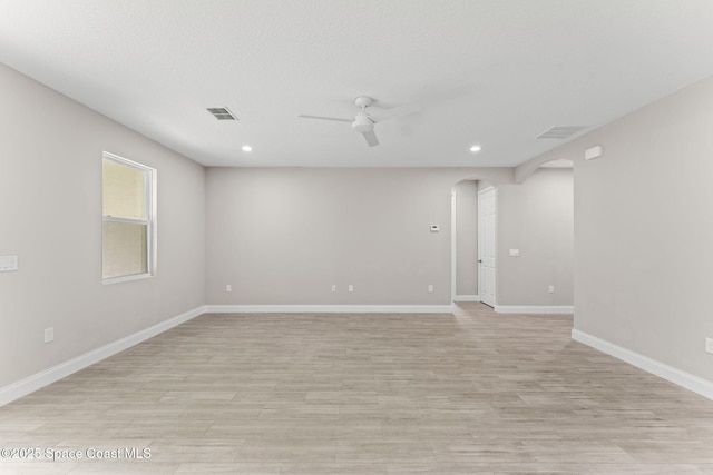 1427 Damon Rd SE, Palm Bay, FL 32909 - empty room with arched walkways, ceiling fan, recessed lighting, light wood-style floors, and baseboards