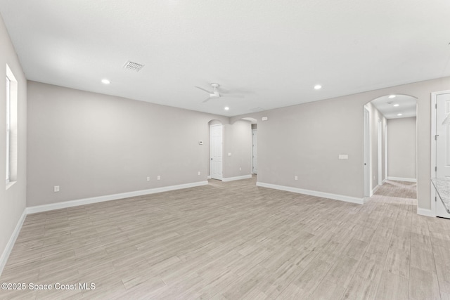1427 Damon Rd SE, Palm Bay, FL 32909 - unfurnished room featuring arched walkways, recessed lighting, ceiling fan, light wood-style flooring, and baseboards