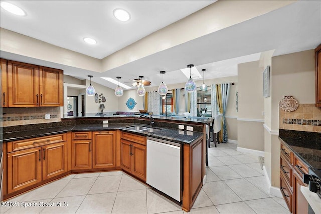 1510 Jupiter Blvd NW, Palm Bay, FL 32907 - kitchen featuring dishwasher, a sink, brown cabinets, tasteful backsplash, and dark stone counters