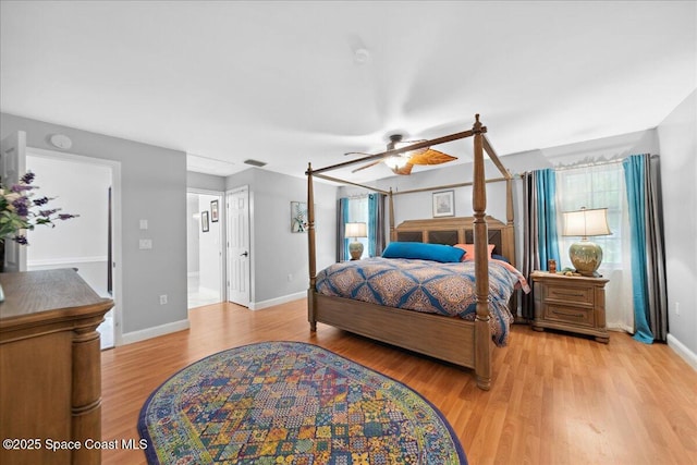 1510 Jupiter Blvd NW, Palm Bay, FL 32907 - bedroom featuring light wood-style floors, multiple windows, baseboards, and a ceiling fan