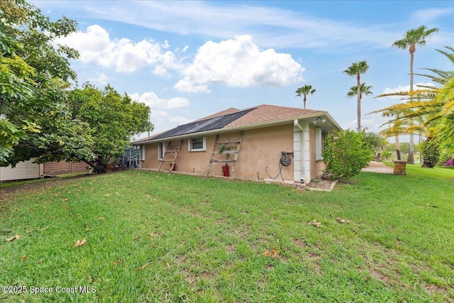 1510 Jupiter Blvd NW, Palm Bay, FL 32907 - rear view of house with stucco siding and a lawn