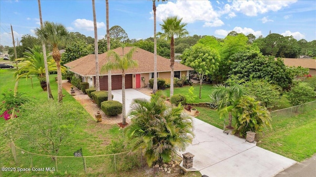 1510 Jupiter Blvd NW, Palm Bay, FL 32907 - view of front of home with driveway, an attached garage, and view of scattered trees