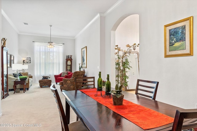 2770 Grand Isle Way SW, Vero Beach, FL 32968 - dining area with ornamental molding, ceiling fan, arched walkways, and light colored carpet
