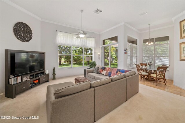 2770 Grand Isle Way SW, Vero Beach, FL 32968 - living area with ornamental molding, plenty of natural light, light carpet, and a ceiling fan