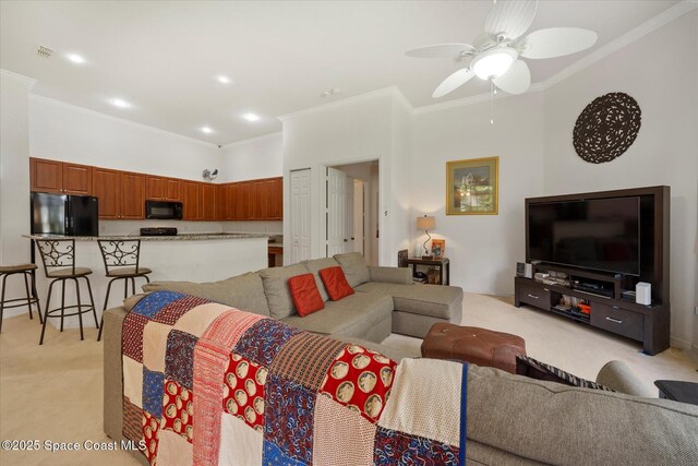 2770 Grand Isle Way SW, Vero Beach, FL 32968 - living room with light carpet, ornamental molding, and a ceiling fan