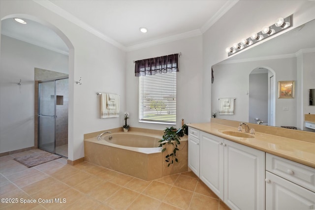2770 Grand Isle Way SW, Vero Beach, FL 32968 - bathroom featuring vanity, a bath, a stall shower, tile patterned flooring, and ornamental molding