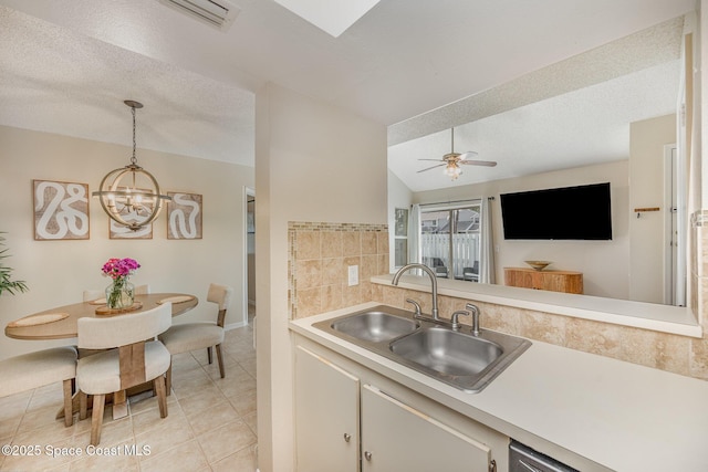 714 Players Ct, Melbourne, FL 32940 - kitchen with a sink, light countertops, a chandelier, light tile patterned floors, and backsplash