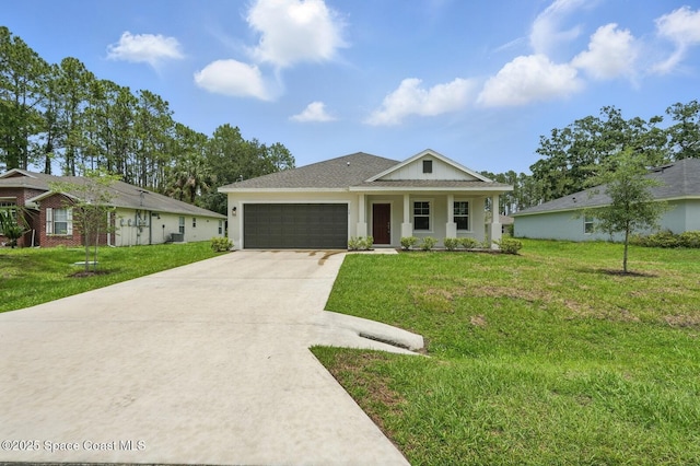 15 Ponderosa Ln, Palm Coast, FL 32164 - view of front of home with a garage, concrete driveway, a front lawn, and stucco siding