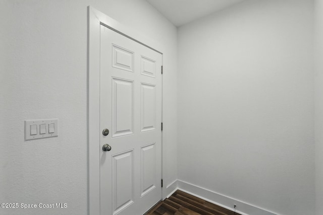 15 Ponderosa Ln, Palm Coast, FL 32164 - doorway to outside featuring dark wood-type flooring and baseboards