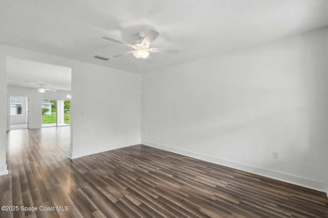 15 Ponderosa Ln, Palm Coast, FL 32164 - empty room featuring a ceiling fan, dark wood-style flooring, and baseboards