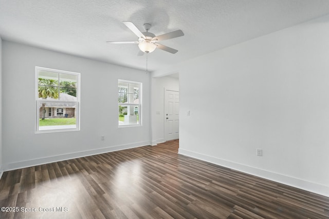 15 Ponderosa Ln, Palm Coast, FL 32164 - unfurnished room featuring dark wood-style flooring, a ceiling fan, baseboards, and a textured ceiling