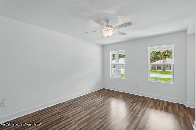15 Ponderosa Ln, Palm Coast, FL 32164 - spare room featuring dark wood-style flooring, ceiling fan, a textured ceiling, and baseboards