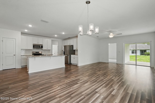 15 Ponderosa Ln, Palm Coast, FL 32164 - kitchen with appliances with stainless steel finishes, open floor plan, a chandelier, dark wood-type flooring, and recessed lighting