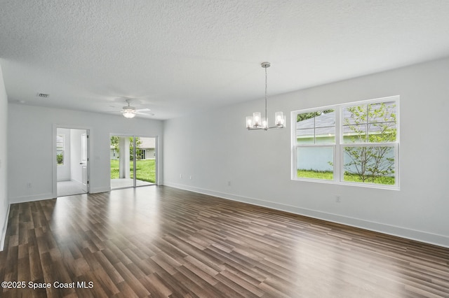 15 Ponderosa Ln, Palm Coast, FL 32164 - empty room featuring a chandelier, baseboards, a ceiling fan, dark wood-style floors, and a textured ceiling