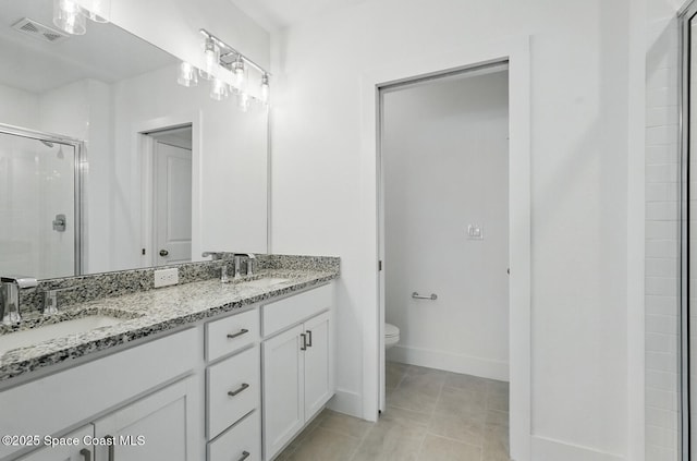 15 Ponderosa Ln, Palm Coast, FL 32164 - bathroom with double vanity, toilet, a stall shower, baseboards, and tile patterned floors