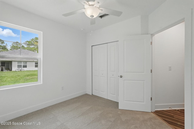 15 Ponderosa Ln, Palm Coast, FL 32164 - unfurnished bedroom featuring a closet, baseboards, and carpet flooring