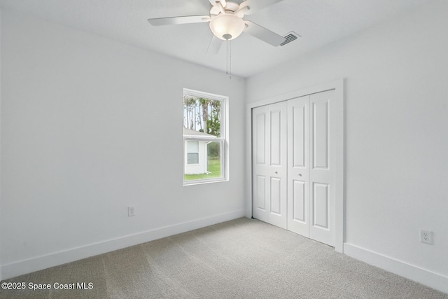 15 Ponderosa Ln, Palm Coast, FL 32164 - unfurnished bedroom with carpet flooring, baseboards, a closet, and a ceiling fan