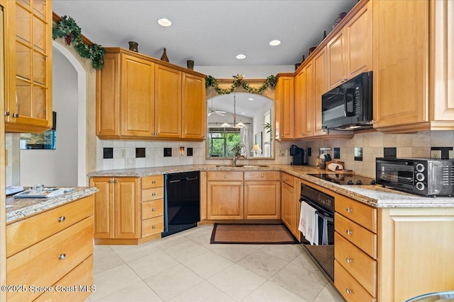 206 Islandia Ct Unit U-206, Satellite Beach, FL 32937 - kitchen with black appliances, decorative backsplash, light stone counters, arched walkways, and recessed lighting