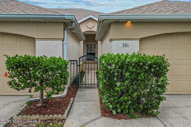 206 Islandia Ct Unit U-206, Satellite Beach, FL 32937 - doorway to property with a shingled roof, a gate, and stucco siding