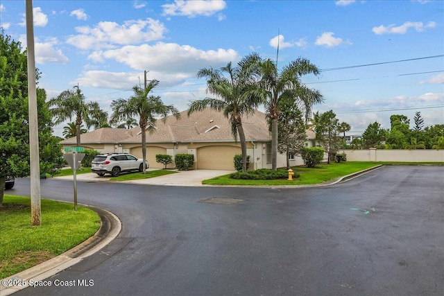 206 Islandia Ct Unit U-206, Satellite Beach, FL 32937 - view of front facade featuring driveway, a garage, and stucco siding