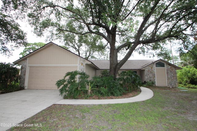 1361 Athens Dr NE, Palm Bay, FL 32907 - view of front of home with stone siding, an attached garage, and concrete driveway