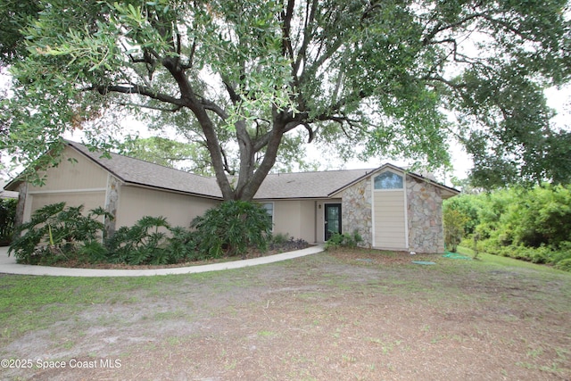 1361 Athens Dr NE, Palm Bay, FL 32907 - mid-century home with stone siding and a garage