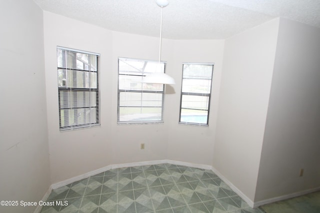 1361 Athens Dr NE, Palm Bay, FL 32907 - empty room with a textured ceiling and baseboards