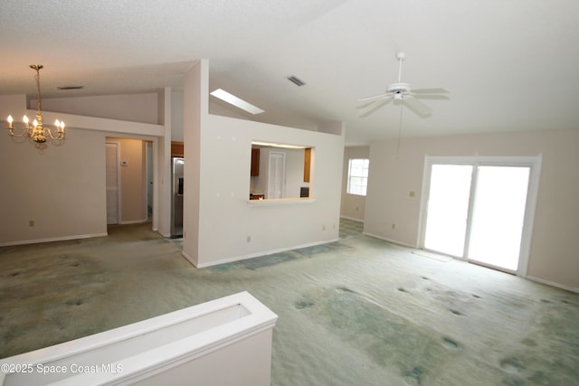 1361 Athens Dr NE, Palm Bay, FL 32907 - unfurnished living room with lofted ceiling, light carpet, baseboards, ceiling fan, and a chandelier