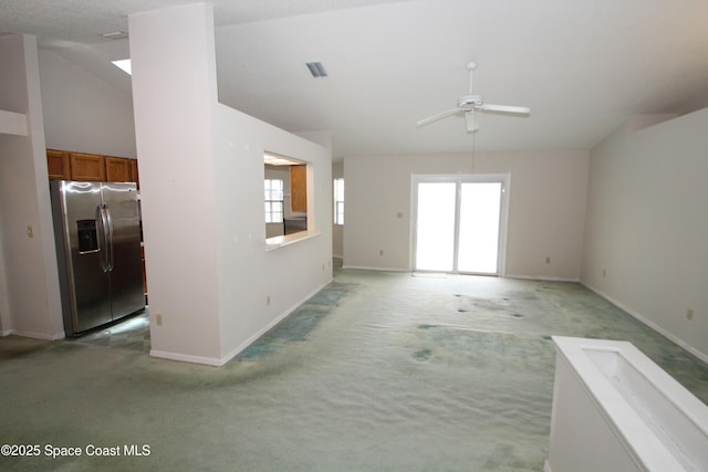 1361 Athens Dr NE, Palm Bay, FL 32907 - unfurnished room with light colored carpet, ceiling fan, baseboards, and vaulted ceiling