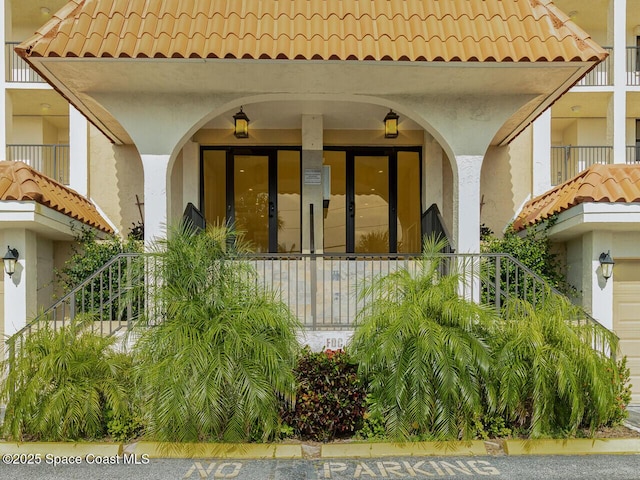 2815 S Atlantic Ave Unit 705, Cocoa Beach, FL 32931 - property entrance featuring a tile roof and stucco siding