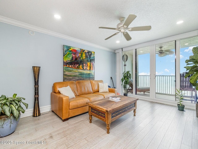 2815 S Atlantic Ave Unit 705, Cocoa Beach, FL 32931 - living area featuring a ceiling fan, light wood-type flooring, ornamental molding, a textured ceiling, and recessed lighting