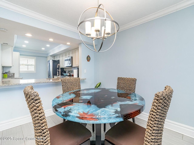 2815 S Atlantic Ave Unit 705, Cocoa Beach, FL 32931 - dining space with crown molding, a chandelier, recessed lighting, and light wood-type flooring